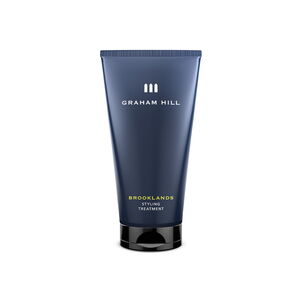 Pflegendes BROOKLANDS Styling Treatment von GRAHAM HILL in einer dunkelblauen 150-ml-Tube mit schwarzem Verschluss.