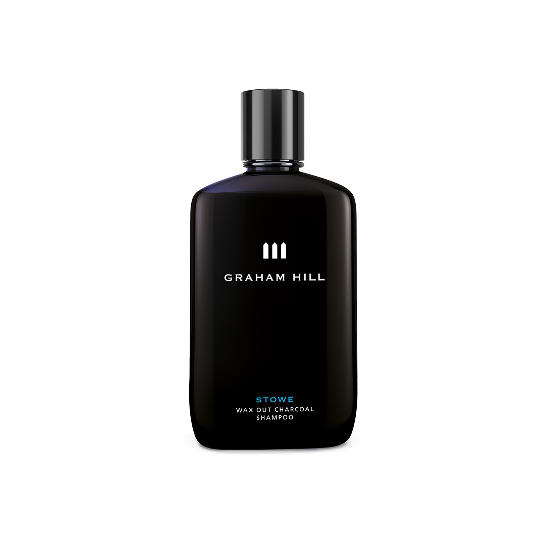 Schwarze Flasche STOWE WAX OUT CHARCOAL SHAMPOO von GRAHAM HILL mit schwarzem Verschluss und weisser Beschriftung.